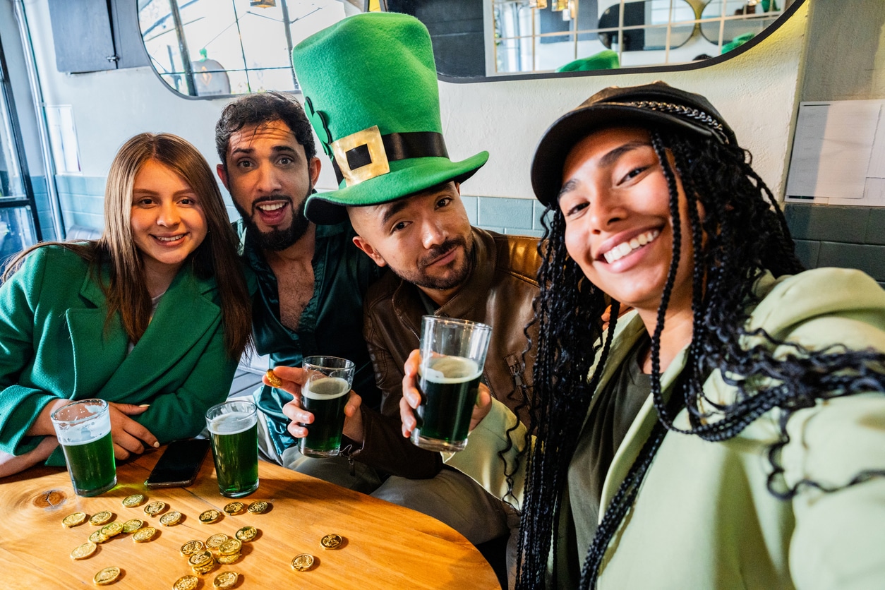 Friends taking a selfie on St. Patrick's day on a bar - Camera point of view