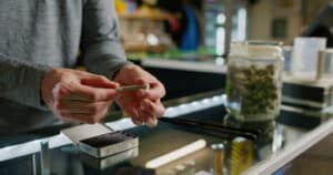 A budtender works inside of a retail cannabis shop in Oregon.