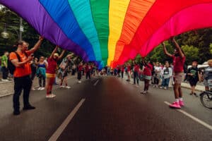 Berlin, Germany, Europe - July 22, 2023: photo of LGBTQIA+ pride month, photography of gay parade in the capital. German LGBT demonstration outdoors with big flag.